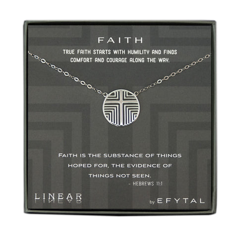 A grey jewelry box containing a grey message card with linear grey cross motif. A sterling silver necklace with a round pendant with the same cross motif pendant rests on the card. The white text on the card reads “FAITH TRUE FAITH STARTS WITH HUMILITY AND FINDS COMFORT AND COURAGE ALONG THE WAY.” At the top and “FAITH IS THE SUBSTANCE OF THINGS HOPED FOR, THE EVIDENCE OF THINGS NOT SEEN. - HEBREWS 11:1 LINEAR by EFYTAL” at the bottom. 