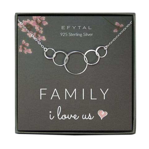 A grey jewelry box containing a grey message card with pink floral motif in the upper corners. A 925 Sterling Silver necklace with five interlocking rings of various size rests on the card. The white text on the card reads “EFYTAL 925 Sterling Silver” at the top and “FAMILY I love us <3” at the bottom.