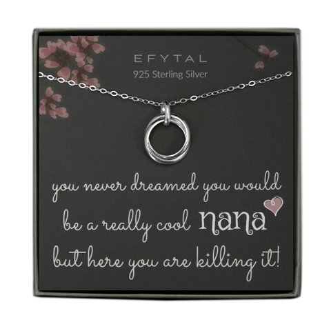 A grey jewelry box holds a grey message card with pink floral branch motifs at the top. A sterling silver necklace with two overlapping thick rings rests on the card. The white text at the top reads "EFYTAL 925 Sterling Silver" and the bottom reads "you never dreamed you would be a really cool NANA <3 but here you are killing it!"
