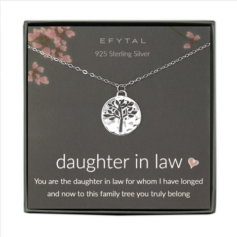 A grey jewelry box containing a grey message card with pink flower motif at the top.  A sterling silver necklace rests on the card. The necklace has a hammered pendant with a tree shaped cutout. The white text on the card reads “EFYTAL 925 Sterling Silver” at the top and “daughter in law <3 You are the daughter in law for whom I have longed and now to this family tree you truly belong”