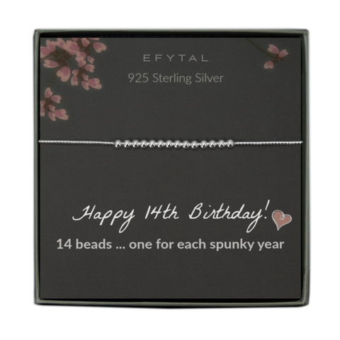  grey jewelry box containing a silver bracelet with fourteen round silver beads, placed on a grey card with pink flowers at the top. the text on the card reads "EFYTAL 925 sterling silver" at the top and "Happy 14th Birthday! <3 14 beads... one for each spunky year" at the bottom.