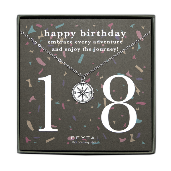 grey jewelry box containing silver necklace with a dimensional compass pendant, placed on a grey card with colorful confetti print and large number 18 in white font. the card reads "happy birthday. embrace every adventure and enjoy the journey!" in white font at the top, and "EFTYAL 925 Sterling Silver" in small print at the bottom.