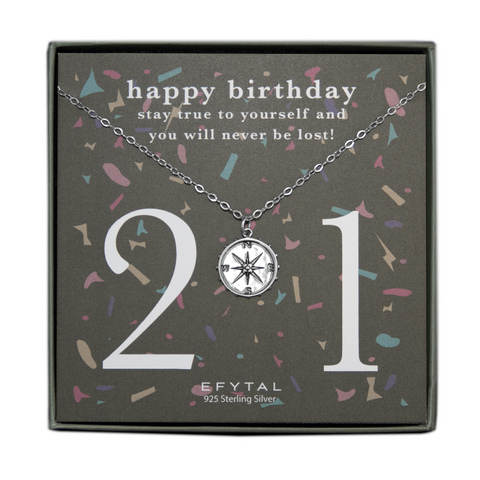 grey jewelry box containing silver necklace with a dimensional compass pendant, placed on a grey card with colorful confetti print and large number 21 in white font. the card reads "happy birthday. stay true to yourself and you will never be lost!" in white font at the top, and "EFTYAL 925 Sterling Silver" in small print at the bottom.
