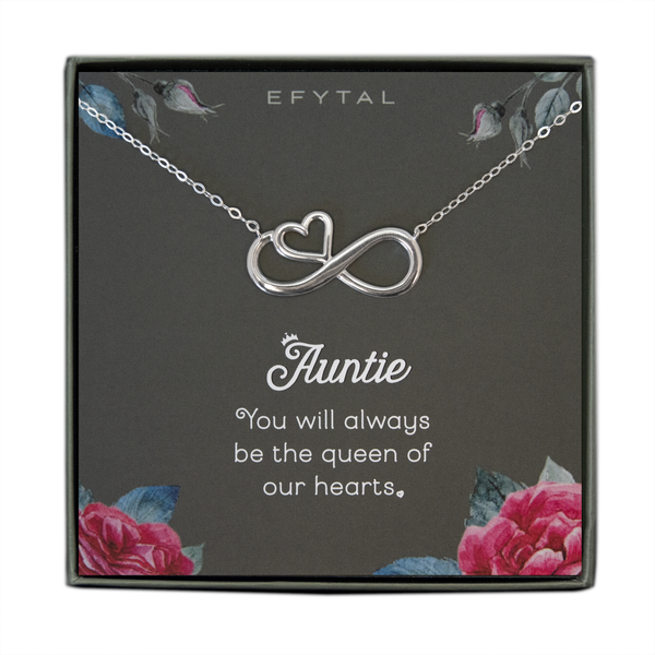  A grey jewelry box containing a grey message card with pink rose motif in the bottom two corners, and rosebuds with leaves in the top two. A sterling silver necklace with a half heart half infinity sign pendant rests on the card. The white text on the card reads "EFYTAL" at the top and “Auntie You will always be the queen of our hearts <3” at the bottom.