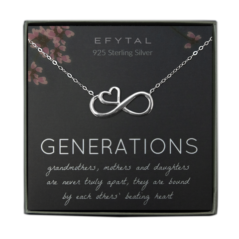A grey jewelry box containing a grey message card with pink floral motif at the top.  A silver necklace with an infinity sign pendant with an embedded heart on it rests on the card. The white text on the card reads "EFYTAL 925 Sterling Silver" at the top and "GENERATIONS grandmothers, mothers and daughters are never truly apart, they are bound by each others' beating heart" at the bottom
