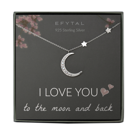 A grey jewelry box contains a grey message card with pink floral motif at the top. A silver necklace with two star stationed beads along the right side and a large crescent moon pendant with embedded CZ stones rests across the card. At the top in white font, the card reads "EFYTAL 925 Sterling Silver." At the bottom, it reads "I LOVE YOU <3 <3 to the moon and back."